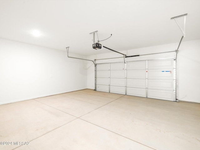 garage featuring baseboards and a garage door opener