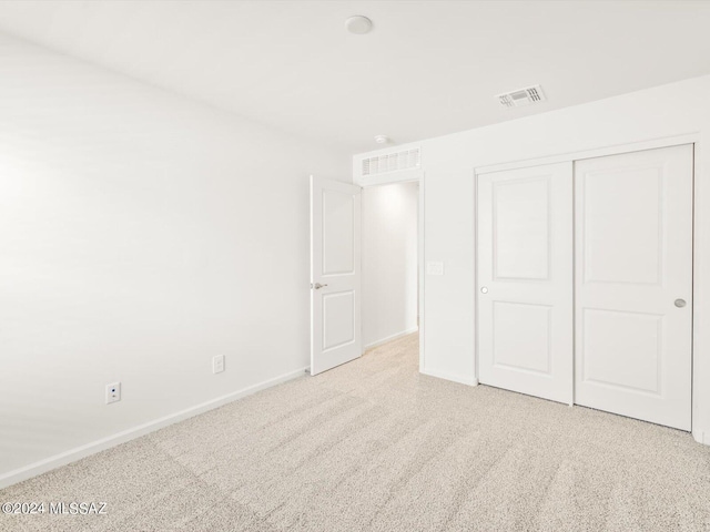 unfurnished bedroom with baseboards, visible vents, and carpet floors