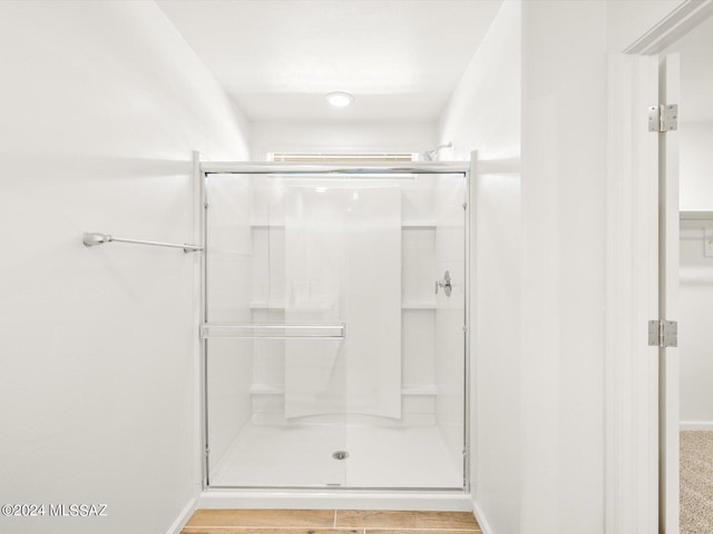 full bath with baseboards and a stall shower