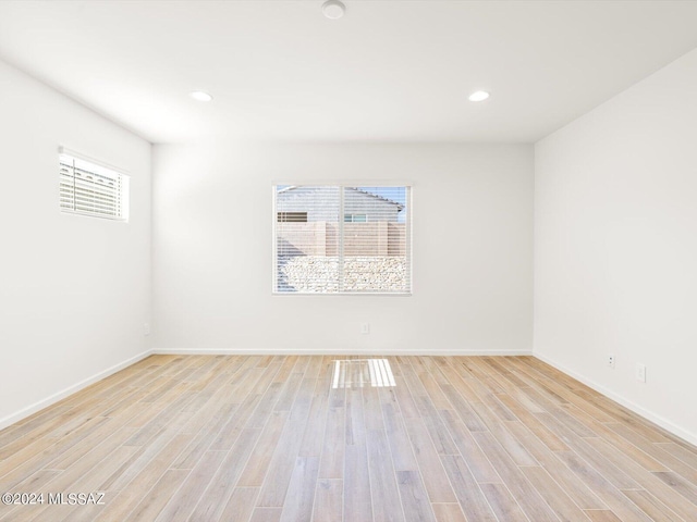 spare room with recessed lighting, baseboards, and light wood-style flooring