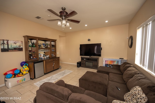 tiled living room featuring ceiling fan and plenty of natural light