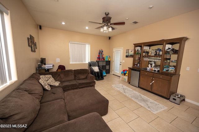 living room featuring light tile patterned floors and ceiling fan