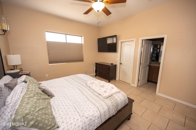 tiled bedroom with ceiling fan and connected bathroom