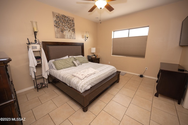 tiled bedroom featuring ceiling fan