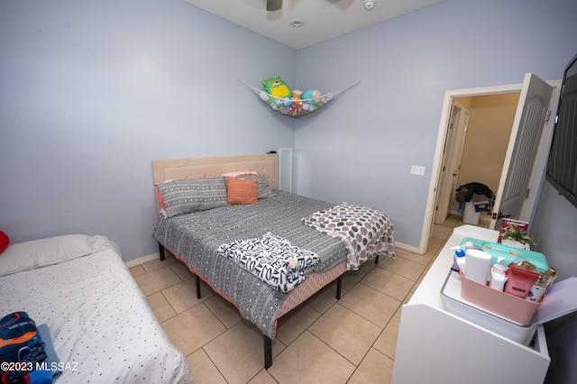 bedroom featuring tile patterned floors and ceiling fan