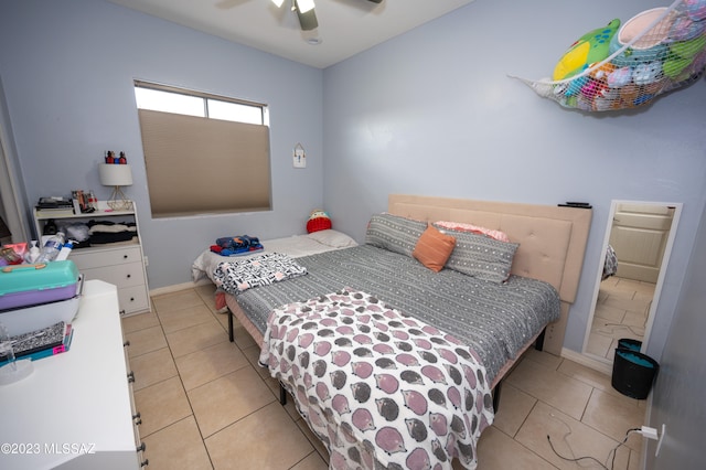 tiled bedroom with ceiling fan