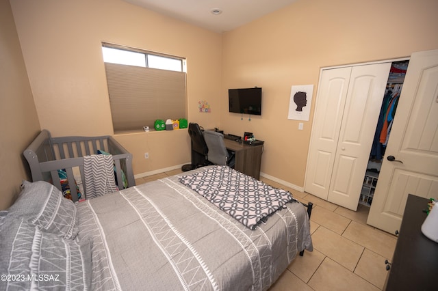 tiled bedroom featuring a closet