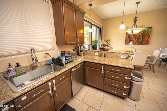 kitchen with decorative light fixtures, kitchen peninsula, light tile patterned floors, and stainless steel dishwasher