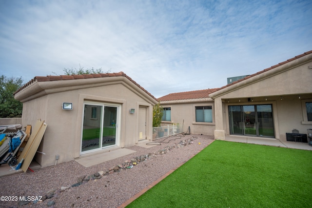 rear view of house featuring a yard