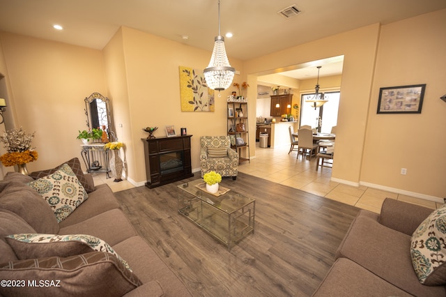 living room featuring an inviting chandelier and hardwood / wood-style flooring