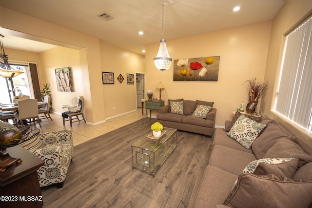 living room with a notable chandelier and hardwood / wood-style floors