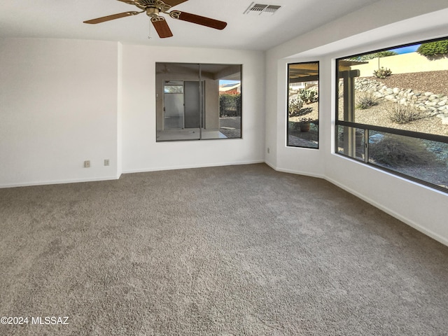 carpeted empty room featuring ceiling fan