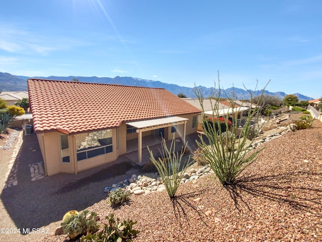 back of house featuring a mountain view