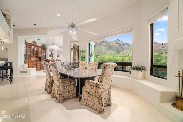 tiled dining area with a mountain view and ceiling fan