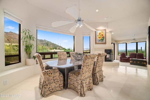 tiled dining space with a mountain view and ceiling fan