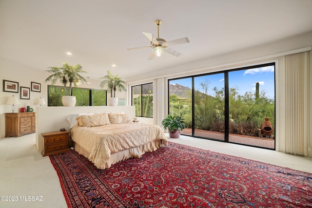 carpeted bedroom featuring access to exterior and ceiling fan