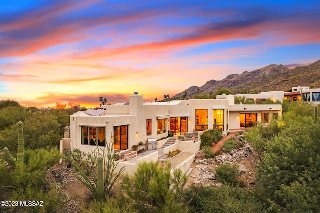 back house at dusk with a mountain view