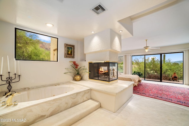 living room with a multi sided fireplace and ceiling fan