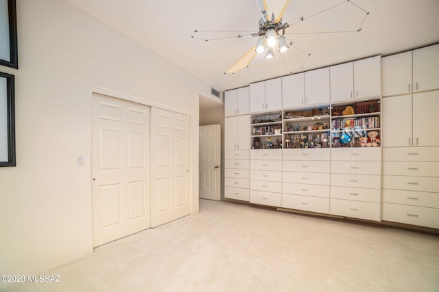 unfurnished bedroom featuring ceiling fan and light colored carpet