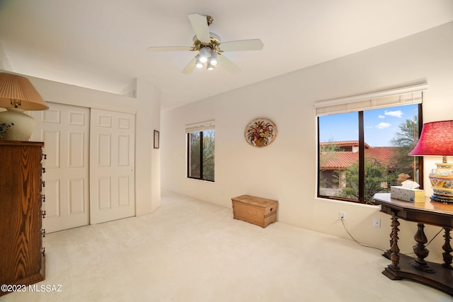 interior space with ceiling fan