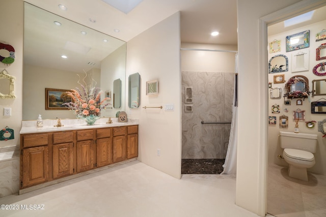 bathroom with toilet, vanity, and walk in shower