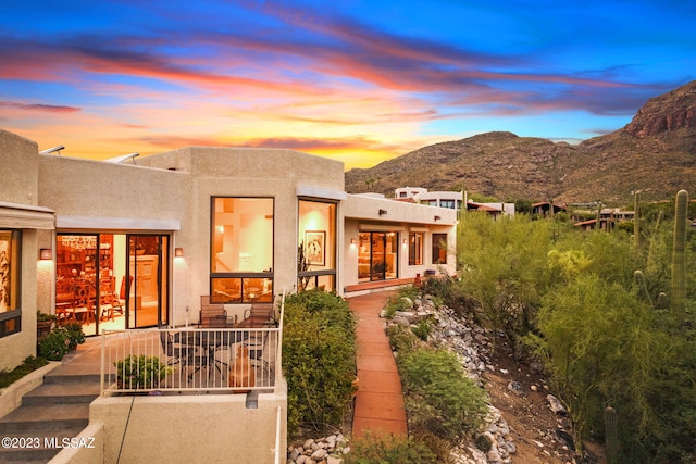 back house at dusk with a mountain view