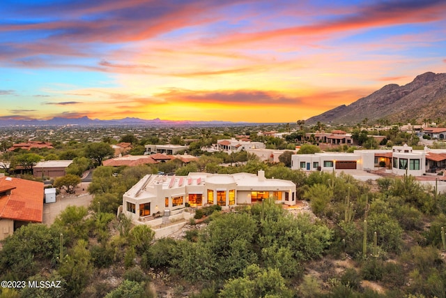 aerial view at dusk featuring a mountain view