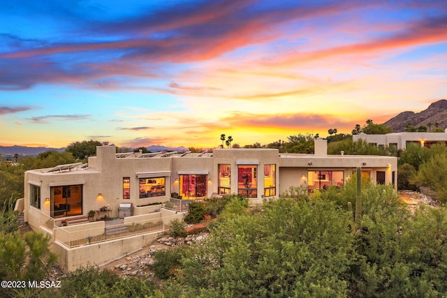 back house at dusk featuring a mountain view