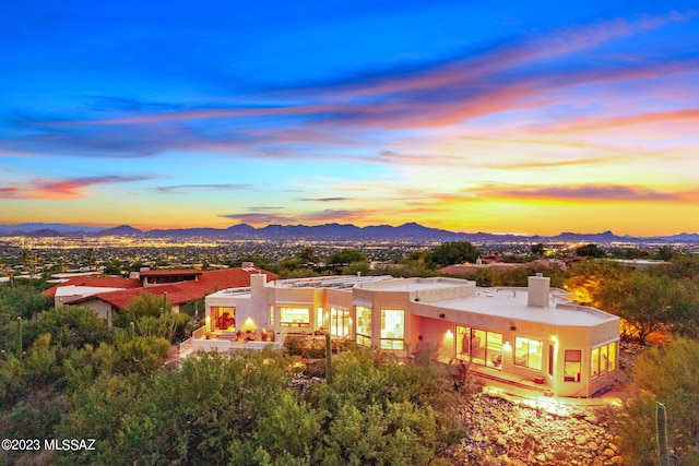 back house at dusk featuring a mountain view