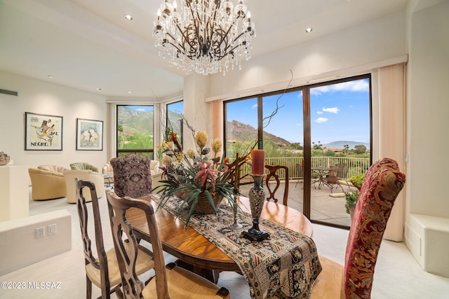 dining space featuring a mountain view and a notable chandelier