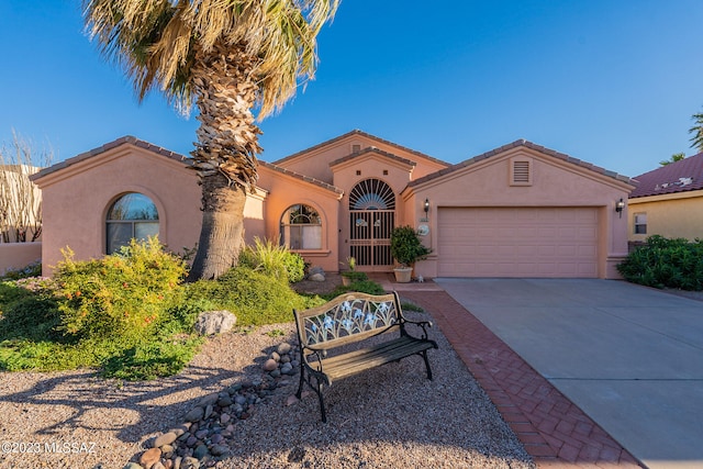 mediterranean / spanish-style home featuring a garage