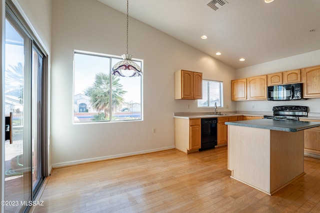 kitchen featuring light hardwood / wood-style floors, a center island, hanging light fixtures, high vaulted ceiling, and black appliances