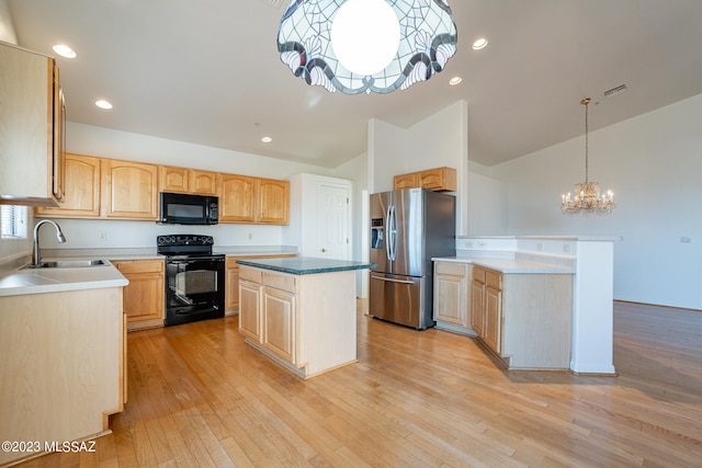 kitchen with pendant lighting, light hardwood / wood-style floors, a center island, sink, and black appliances