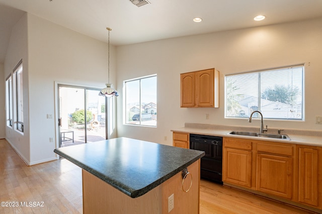 kitchen with dishwasher, a wealth of natural light, sink, and a center island