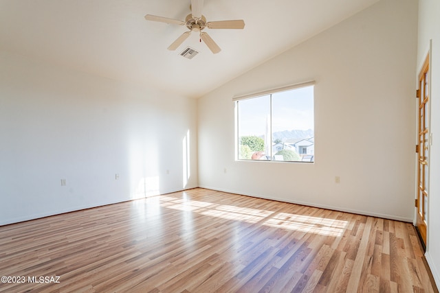 empty room featuring ceiling fan, light hardwood / wood-style floors, and high vaulted ceiling