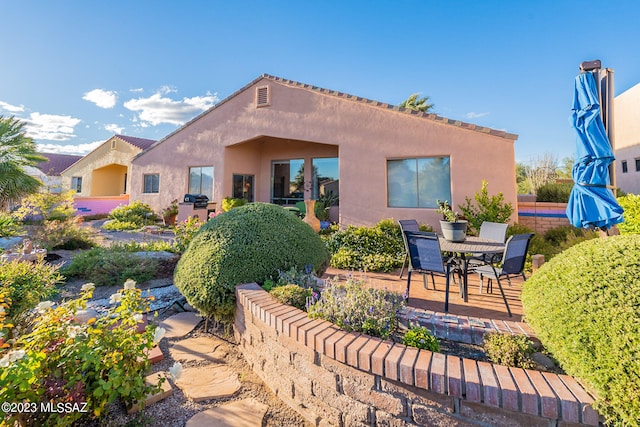 back of house with a patio