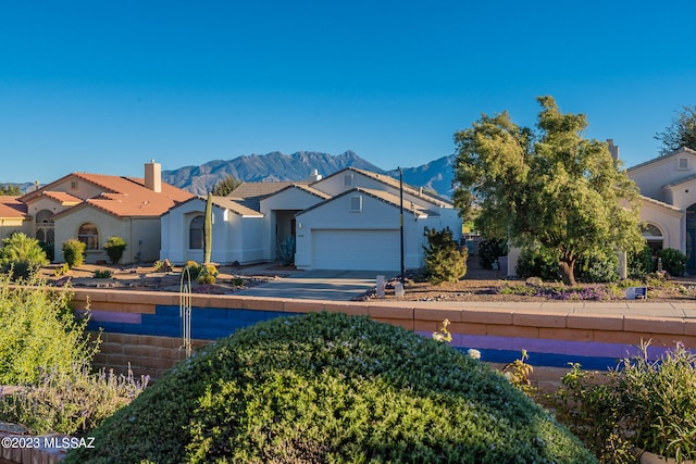 view of front of home with a mountain view and a garage