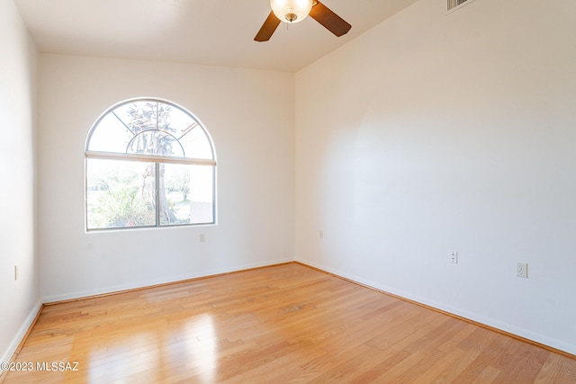 empty room with light hardwood / wood-style floors, ceiling fan, and vaulted ceiling