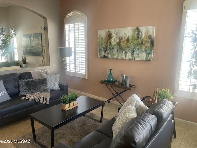 living room with baseboards and tile patterned flooring