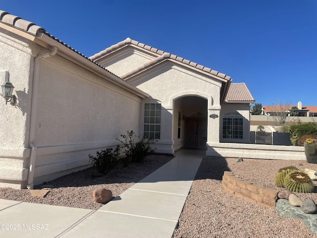 view of front of house with a tiled roof and stucco siding