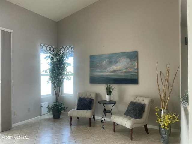 sitting room featuring tile patterned flooring and baseboards