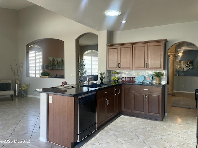 kitchen featuring light tile patterned floors, sink, black dishwasher, and kitchen peninsula