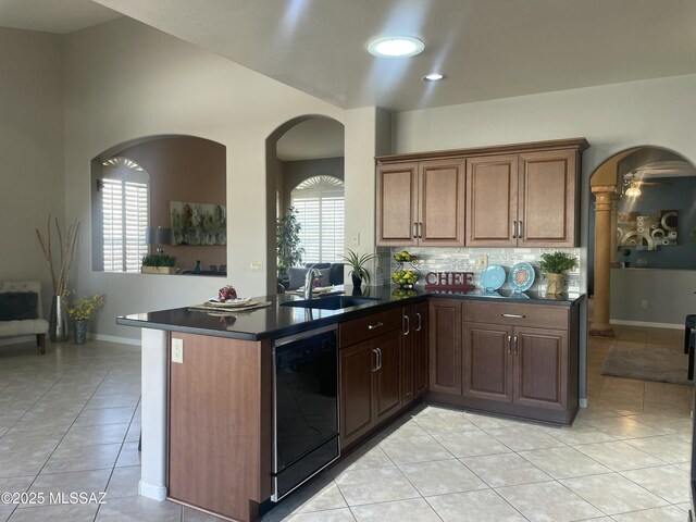 kitchen with light tile patterned flooring, tasteful backsplash, dark stone counters, and black appliances