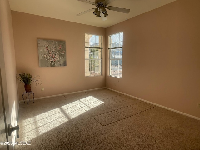 spare room with carpet flooring, a ceiling fan, and baseboards