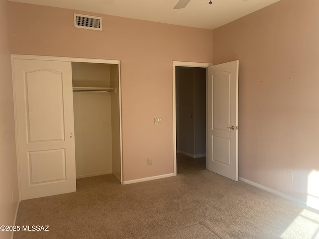 unfurnished bedroom with a closet, baseboards, visible vents, and carpet floors