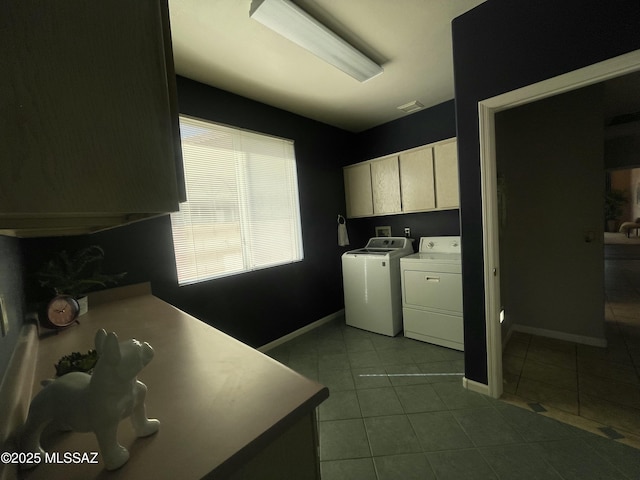 laundry area with light tile patterned floors, cabinets, and washer and clothes dryer