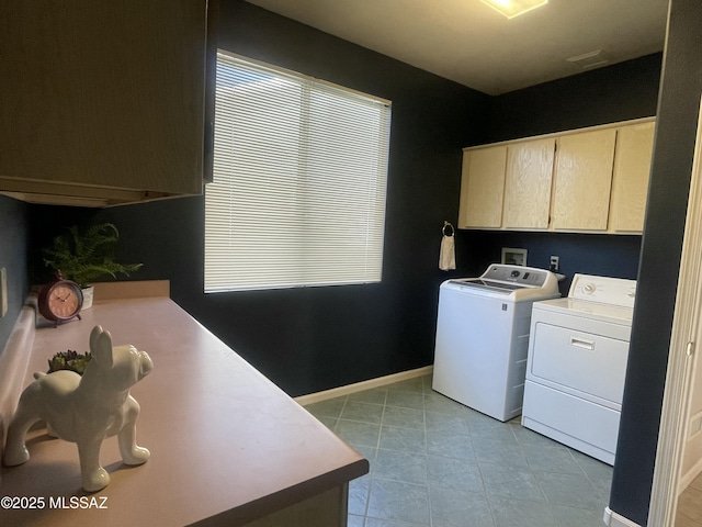 laundry area featuring cabinet space, baseboards, and separate washer and dryer