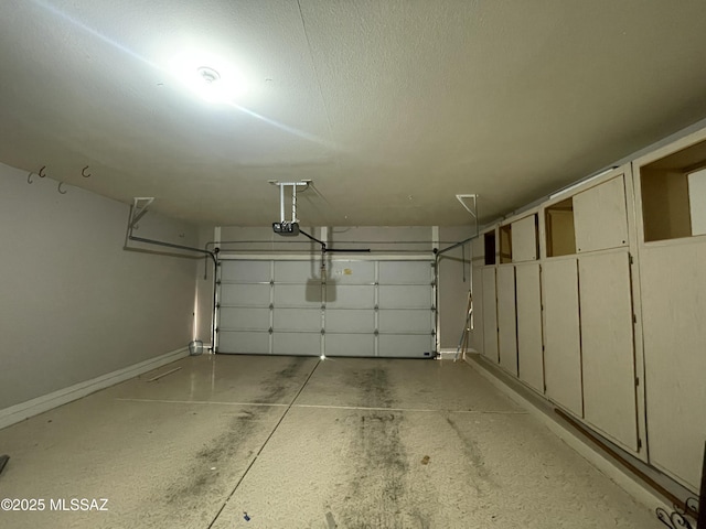 garage featuring baseboards and a garage door opener