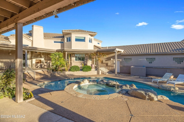 view of swimming pool with a patio and an in ground hot tub