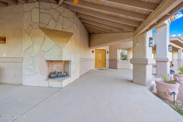 view of patio / terrace featuring an outdoor stone fireplace